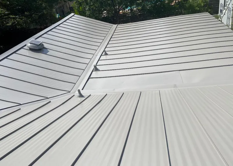 Solar attic fan installed on a metal roof for Roof Ventilation in Portland